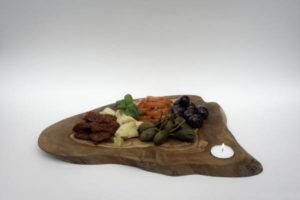 olive wood board with candle and aperitivo